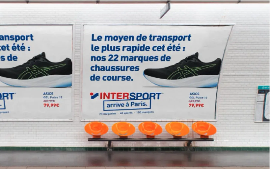 Intersport "arrive à Paris" poster running in a Paris metro station