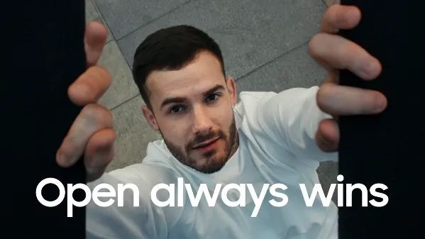 Samsung "Open always wins" campaign still: an athlete reaching towards the camera with the slogan overlaid