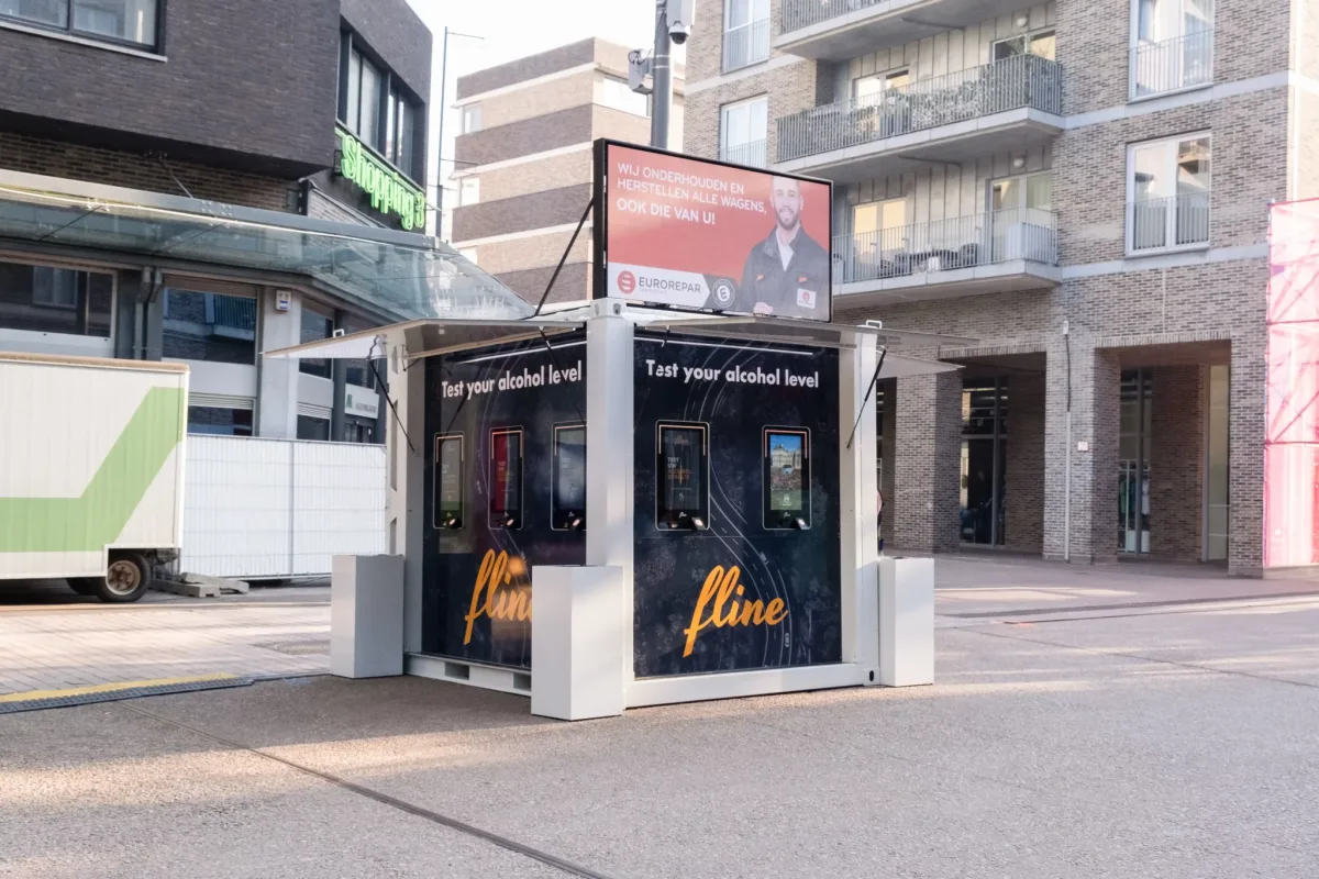 FlineBooth breathalyser booth on a shopping street, five test screens on its side and a large advertising screen on top