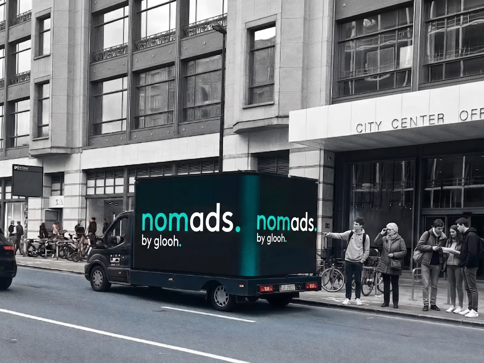 A glooh NomAds activation on a Brussels city centre street, its screen facing pedestrians on the pavement