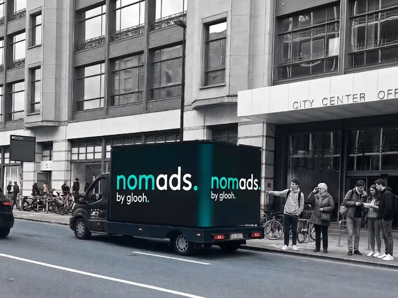glooh NomAds campaign on a Brussels city centre street, screen facing pedestrians